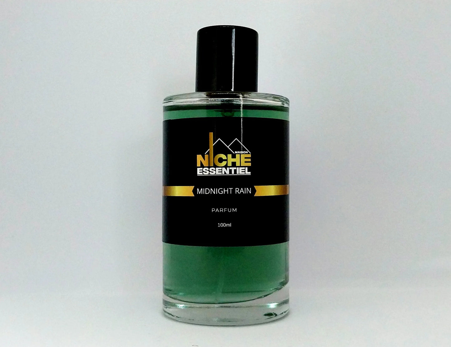 100ml bottle of Niche Essentiel Midnight Rain perfume with a black label and green liquid.