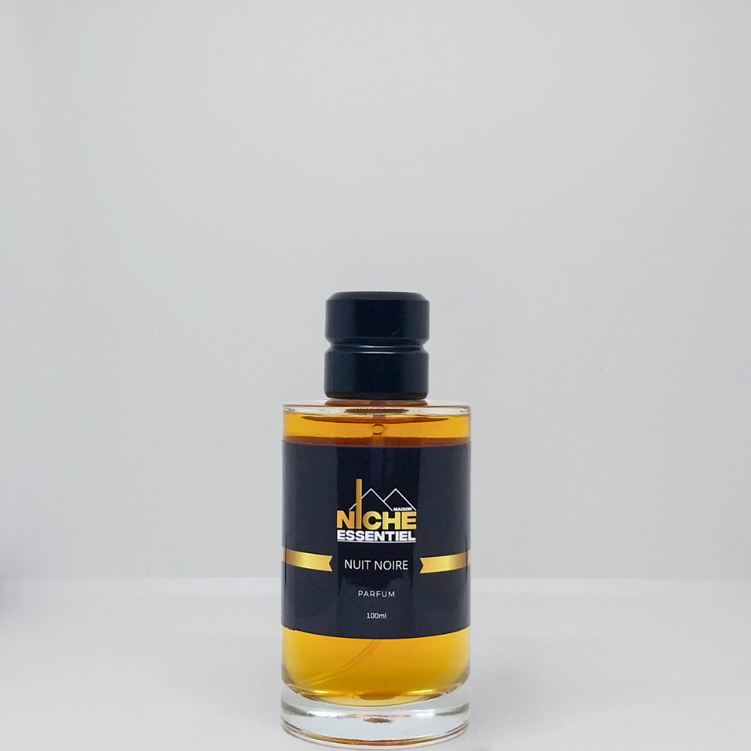 Glass bottle of Niche Essentiel Nuit Noire perfume with a black label and gold accents.