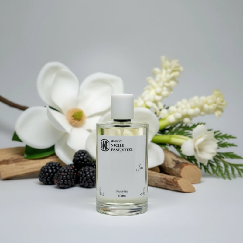 Clear glass perfume bottle labeled 'Maison Niche Essentiel' with a white cap and 100ml capacity.