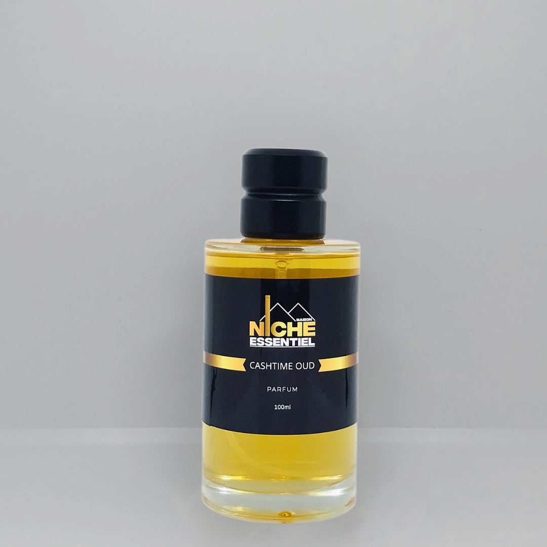 Transparent bottle of Cashtime Oud perfume with a black label and gold accents, containing yellow liquid.