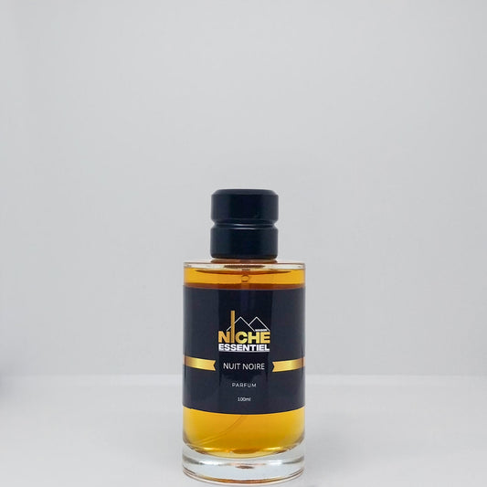 Glass bottle of Niche Essentiel Nuit Noire perfume with a black label and gold accents.