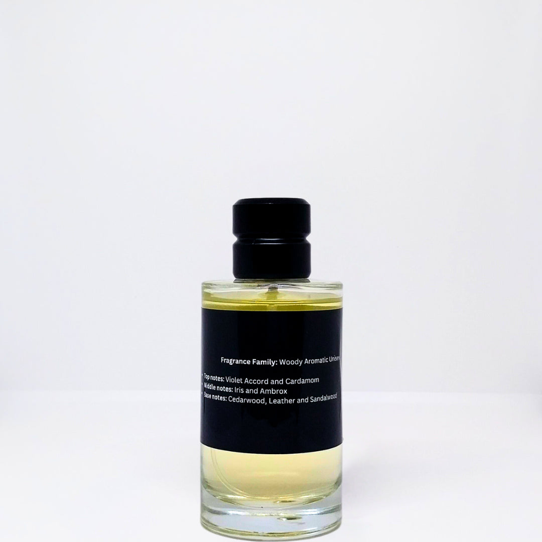 Clear glass bottle of woody aromatic fragrance with a black label and a black cap.