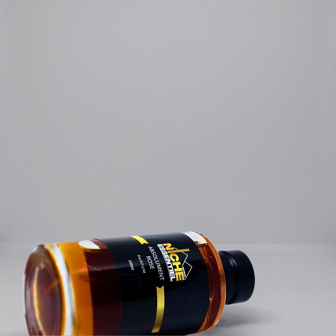 Flat bottle of Absolument Rose with a black label and a gold stripe, positioned on its side.