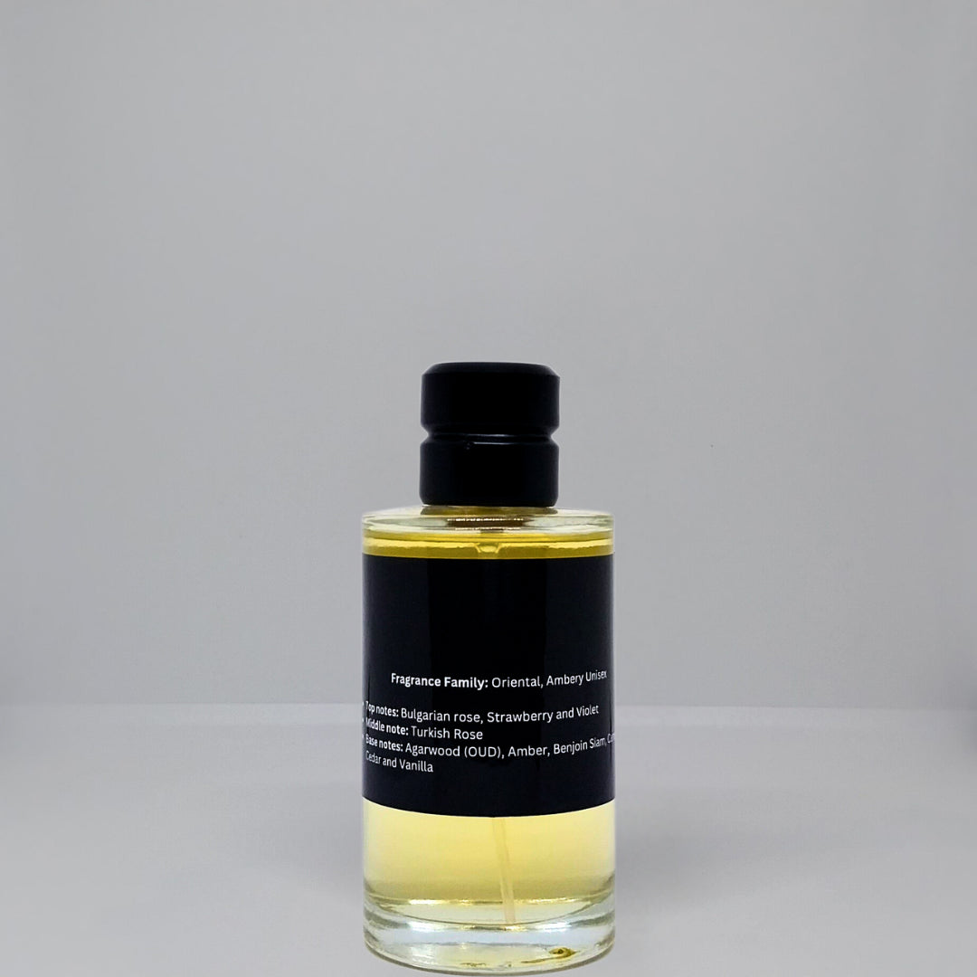 A clear glass bottle of fragrance with a black label and a black cap, containing a yellow liquid.