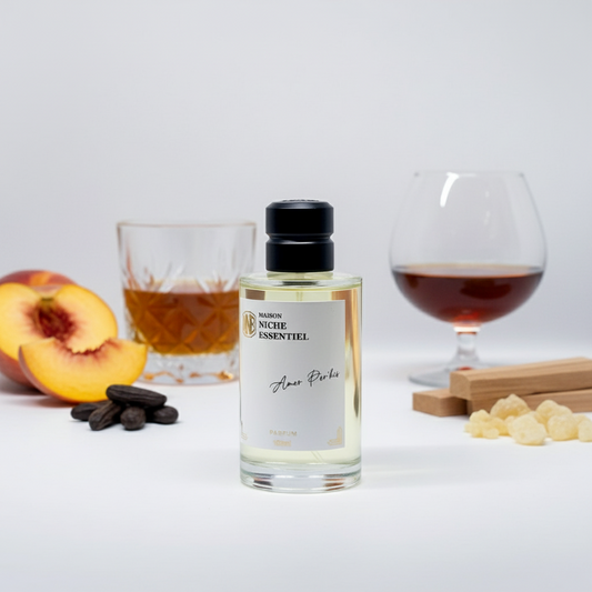 Clear glass perfume bottle with a black cap labeled 'Maison Niche Essentiel Amer Perkis'.