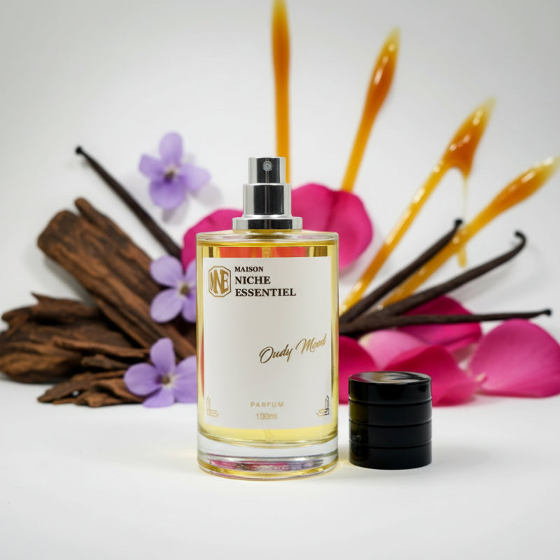 Maison Niche Essentiel Oudy Mood perfume bottle with a black cap and clear liquid inside.